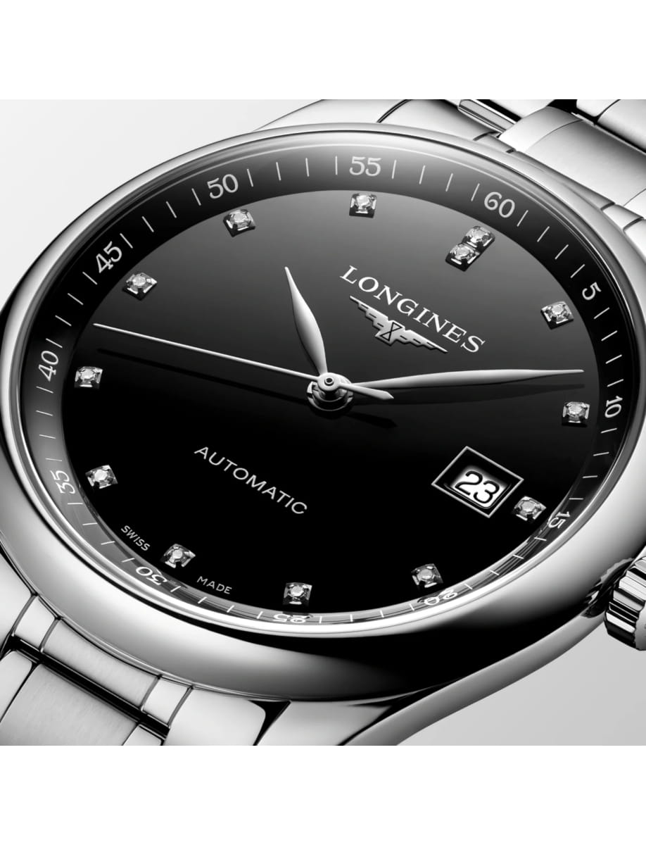 Close-up of a black dial Longines automatic wristwatch with diamond hour markers and date window