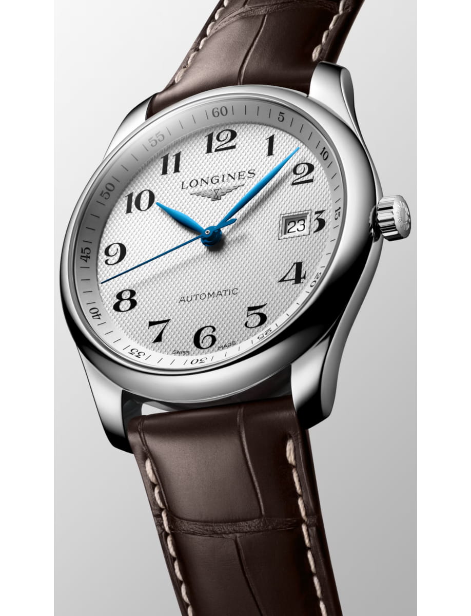 Longines automatic wristwatch with white textured dial, blue hands, and a brown leather strap.
