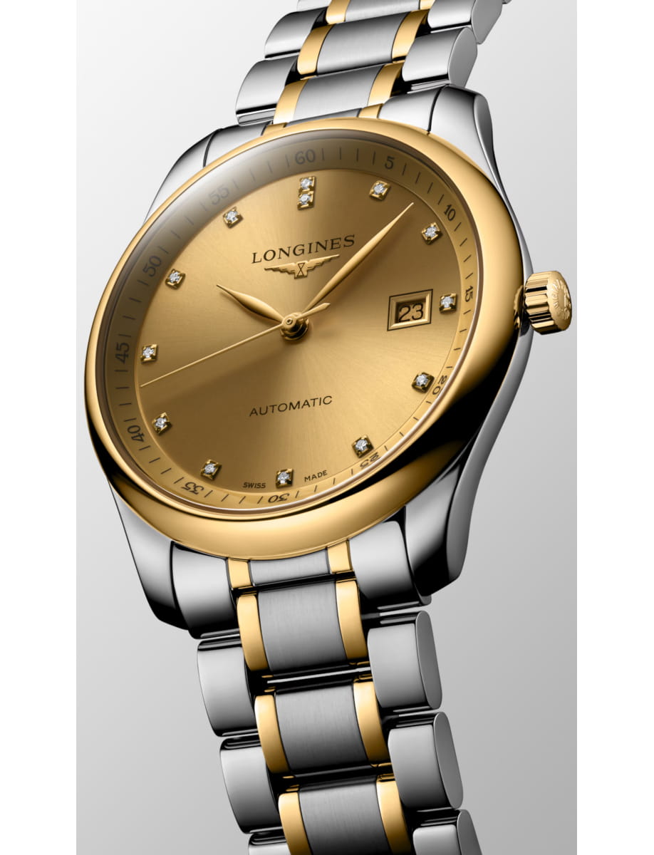 Two-tone gold and silver Longines wristwatch with diamond hour markers and date window, close-up shot emphasizing the polished bracelet and gold dial.