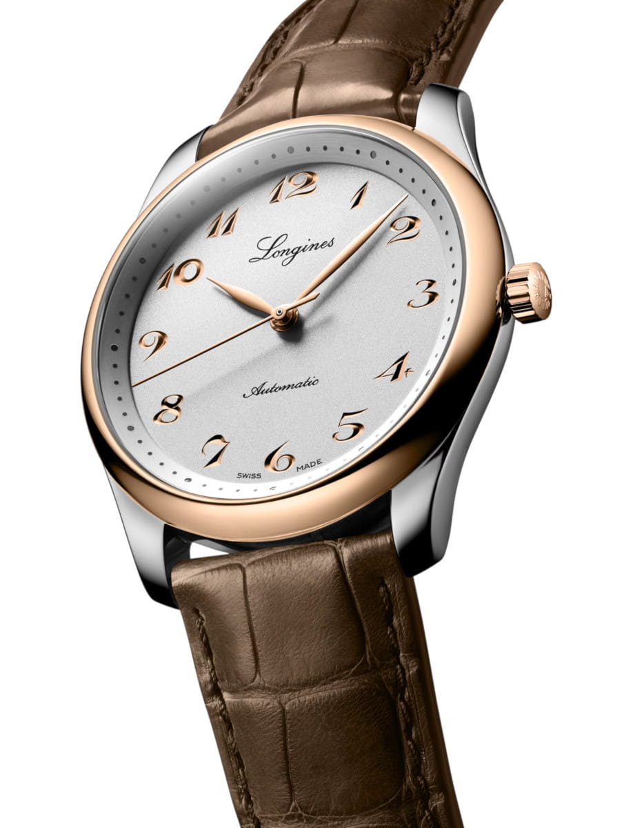Longines wristwatch with a silver dial, rose-gold bezel, and brown leather strap.