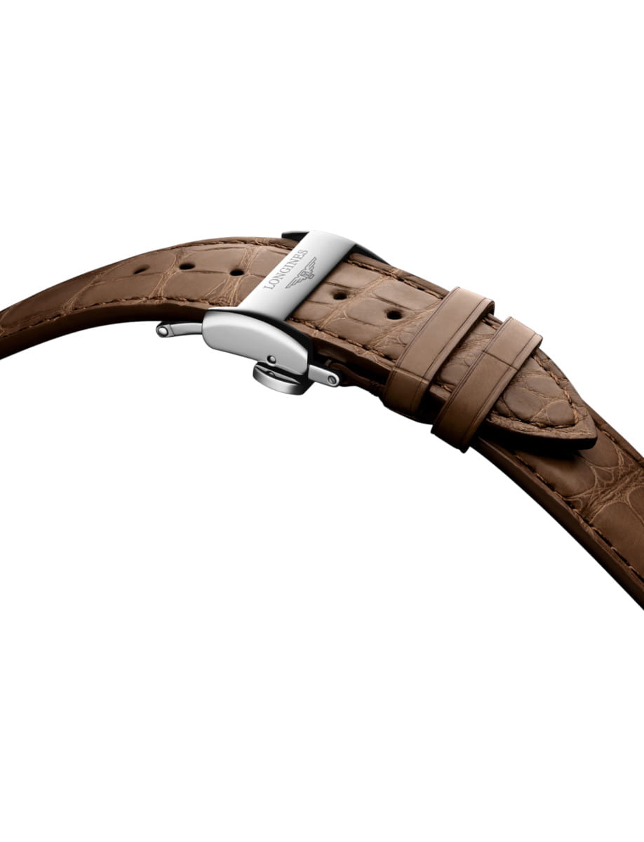 Brown leather watch strap with a silver deployment clasp, shown against a white background.