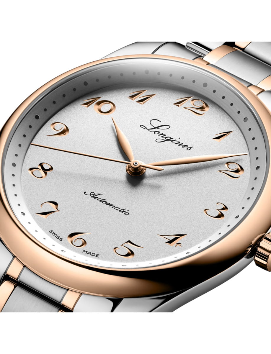 Two-tone luxury Longines wristwatch with a silver dial, gold numerals, and a two-tone metal bracelet.