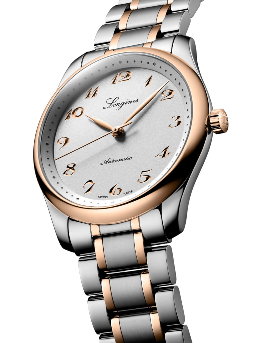 Longines automatic wristwatch with a silver dial, rose-gold bezel, and two-tone metal bracelet.