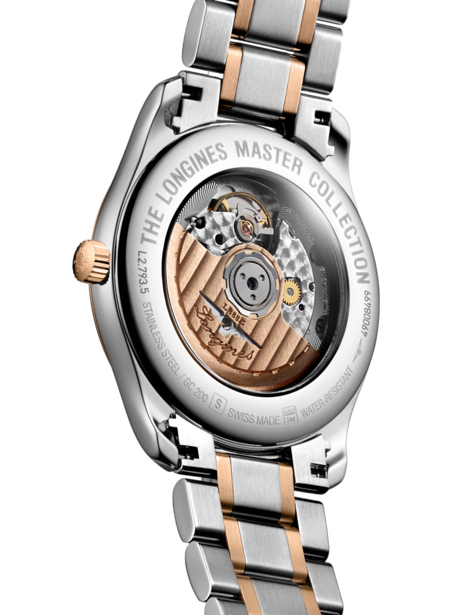 Stainless steel wristwatch with a two-tone bracelet; view of the open caseback showing the mechanical movement inside