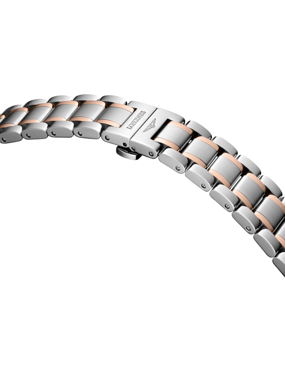 Two-tone metal watch bracelet close-up with silver and rose-gold links highlighting a clasp.