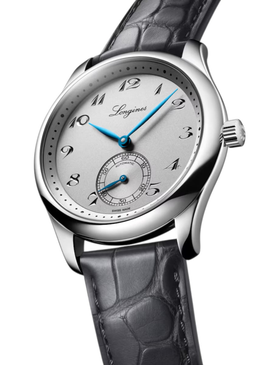 Longines automatic wristwatch with a silver dial, blue hands, and a grey leather strap.