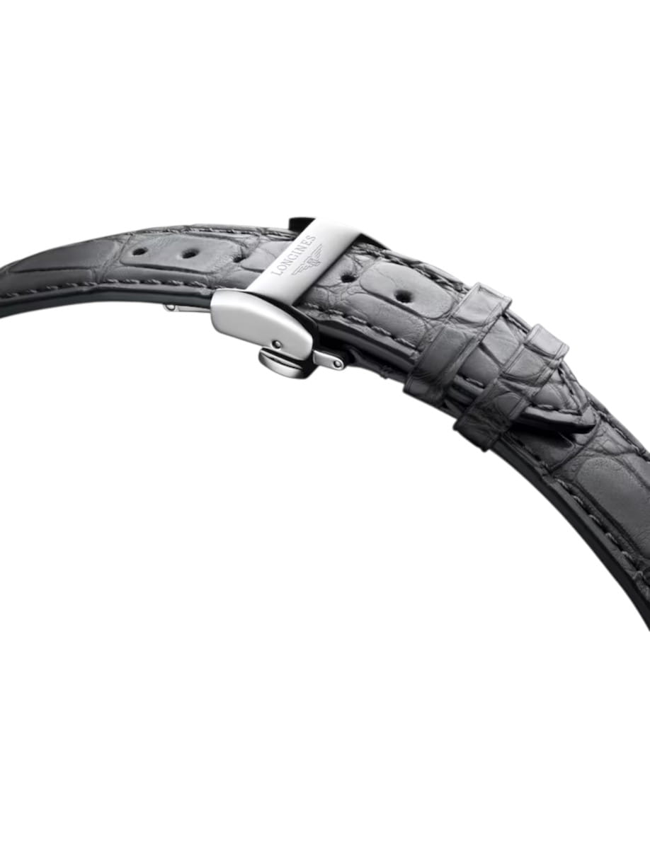 Close-up of a stainless steel deployment clasp on a grey alligator leather watch strap.