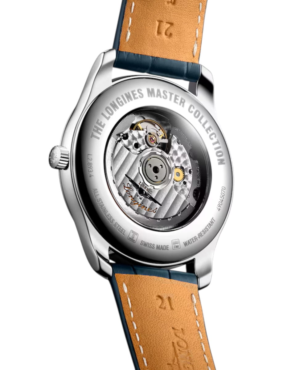 Back view of a silver wristwatch with visible mechanical movement and tan leather strap