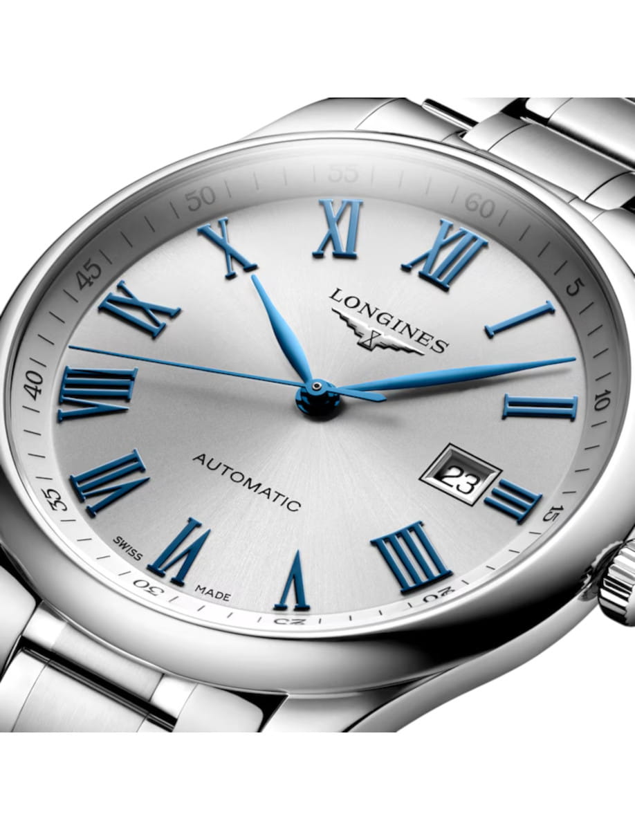 Silver-toned Longines wristwatch with a metal bracelet, blue Roman numerals, and a date window at 3 o'clock (automatic).”,