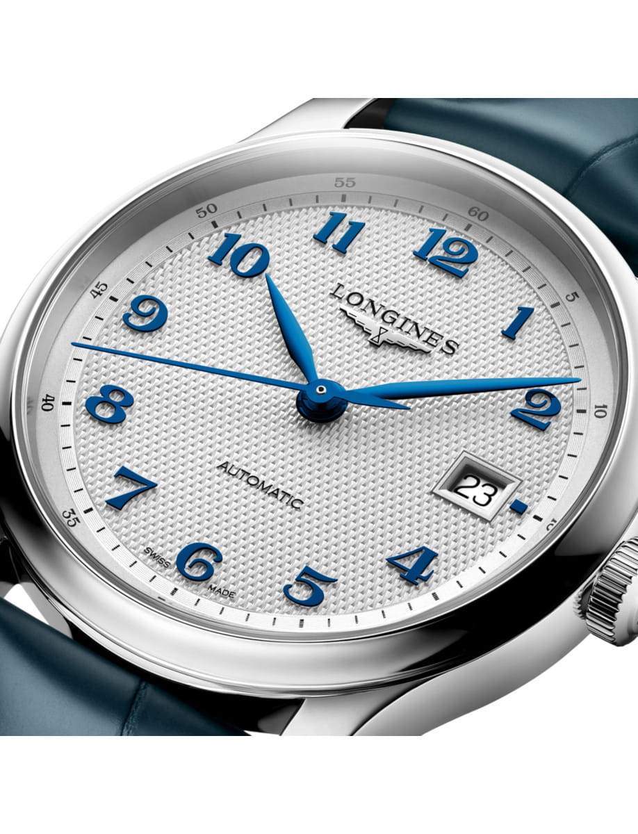 Close-up of a Longines automatic wristwatch with blue numerals and hands, date showing 23