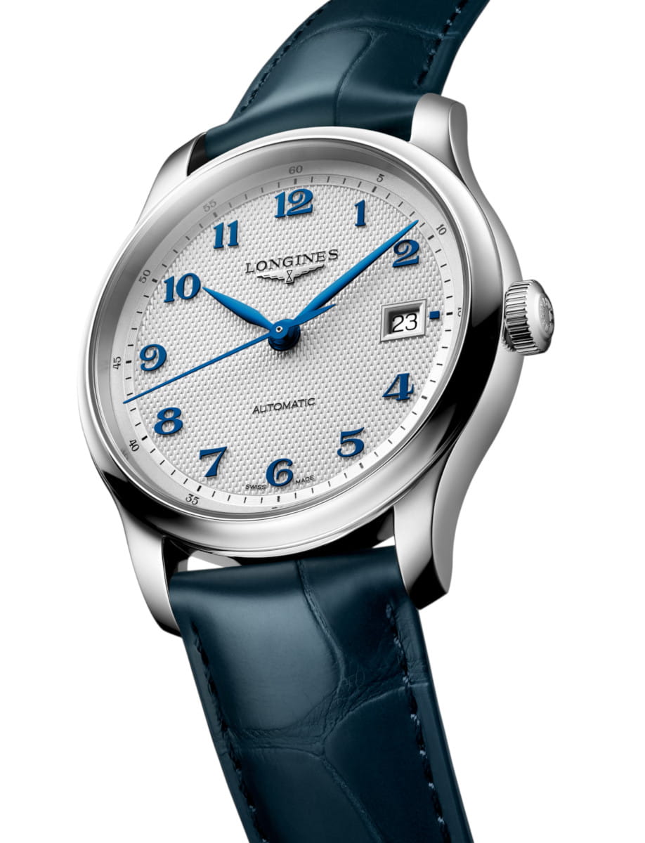 Longines automatic wristwatch with a white textured dial, blue numerals and hands, and a date window at 3 o'clock on a blue leather strap