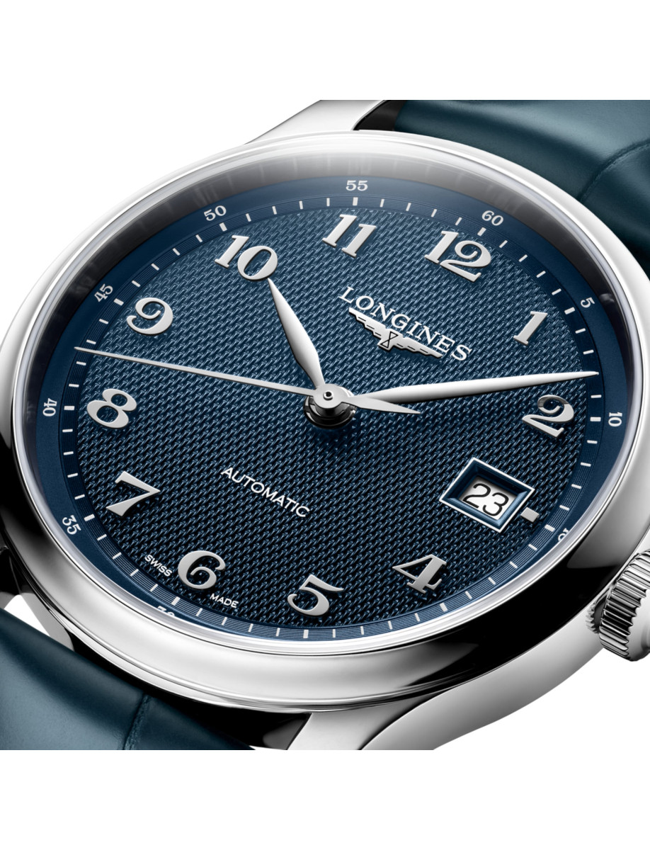 Close-up of a Longines automatic wristwatch with a blue textured dial, stainless steel hands, and a date window at 3 o'clock.