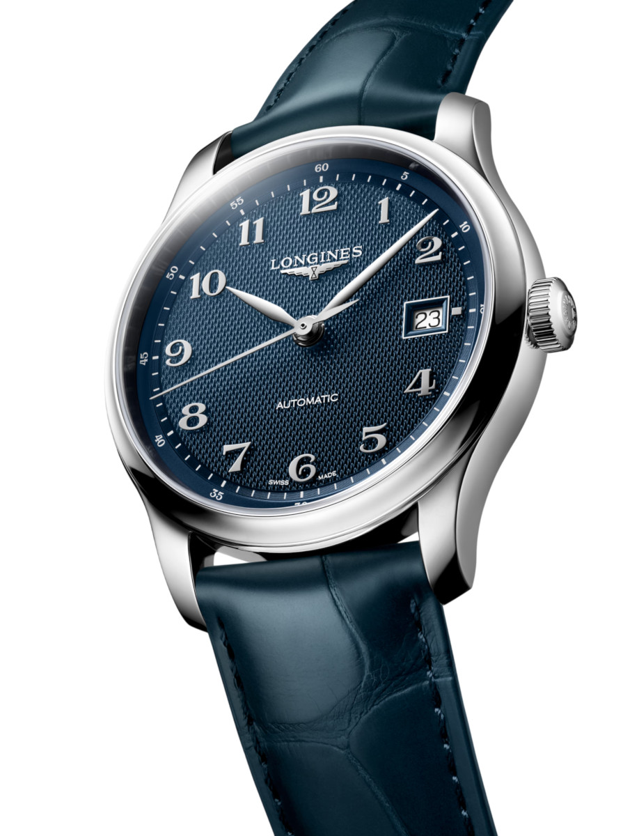 Longines automatic wristwatch with a blue textured dial, stainless steel numerals, and a blue leather strap with a date window at 3 o'clock