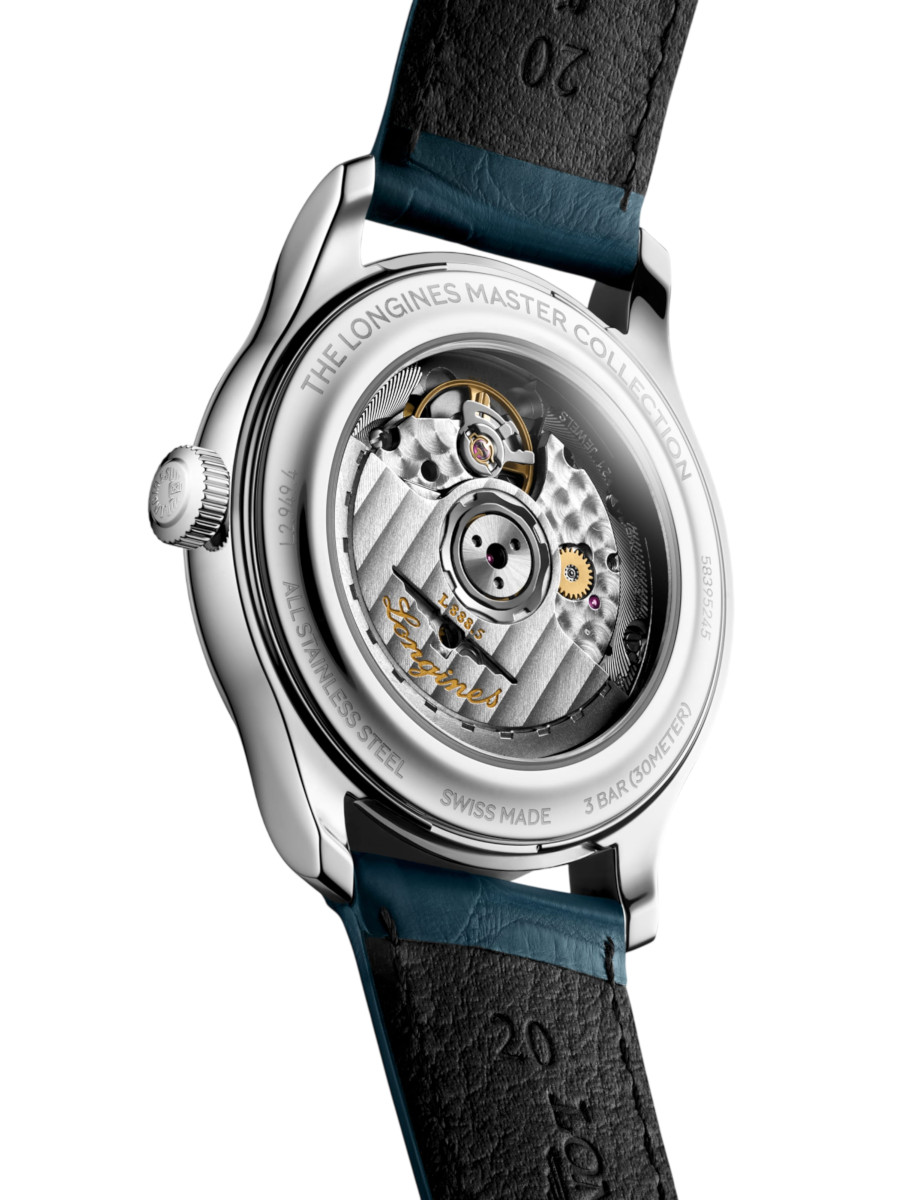Back view of a stainless steel Longines Master Collection watch with a transparent caseback showing the intricate mechanical movement and blue leather strap