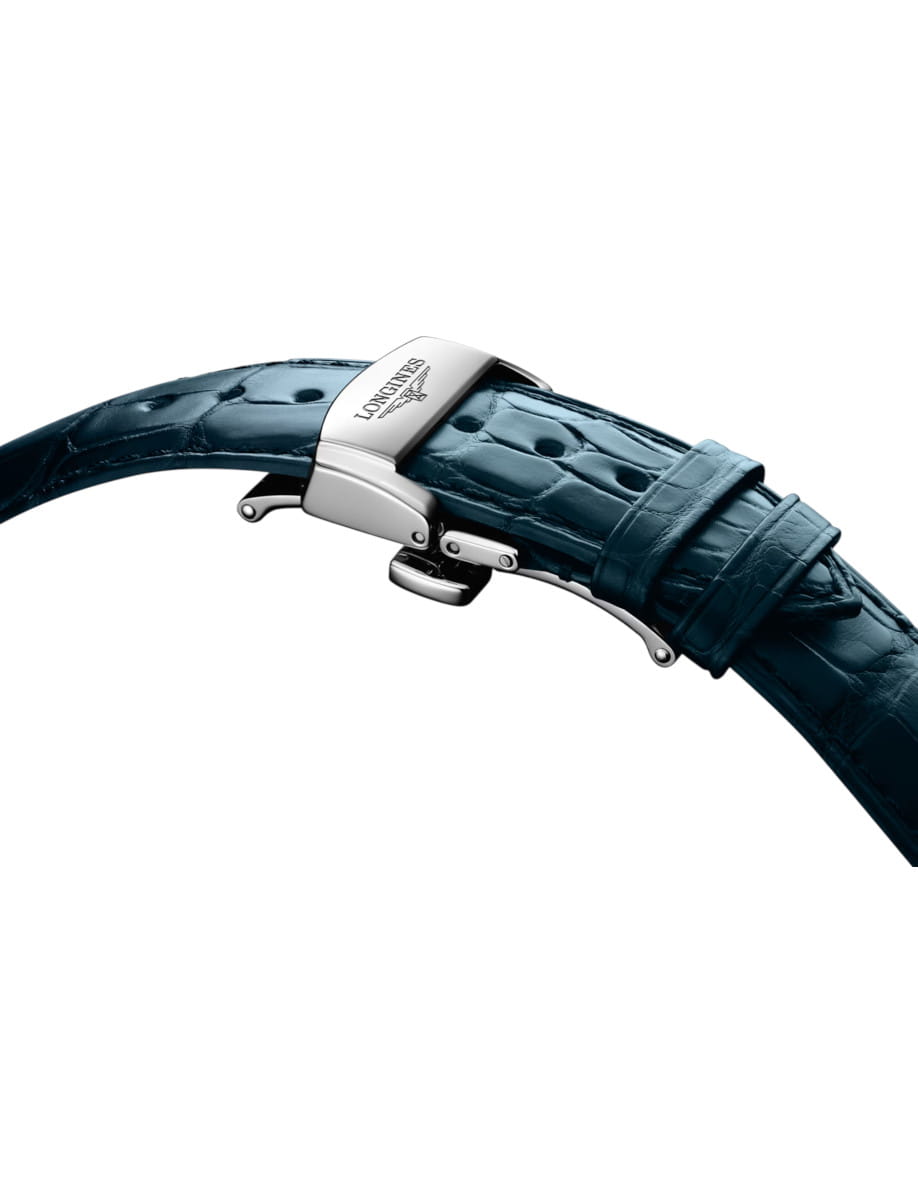 Close-up of a stainless steel deployment clasp on a blue alligator leather watch strap.