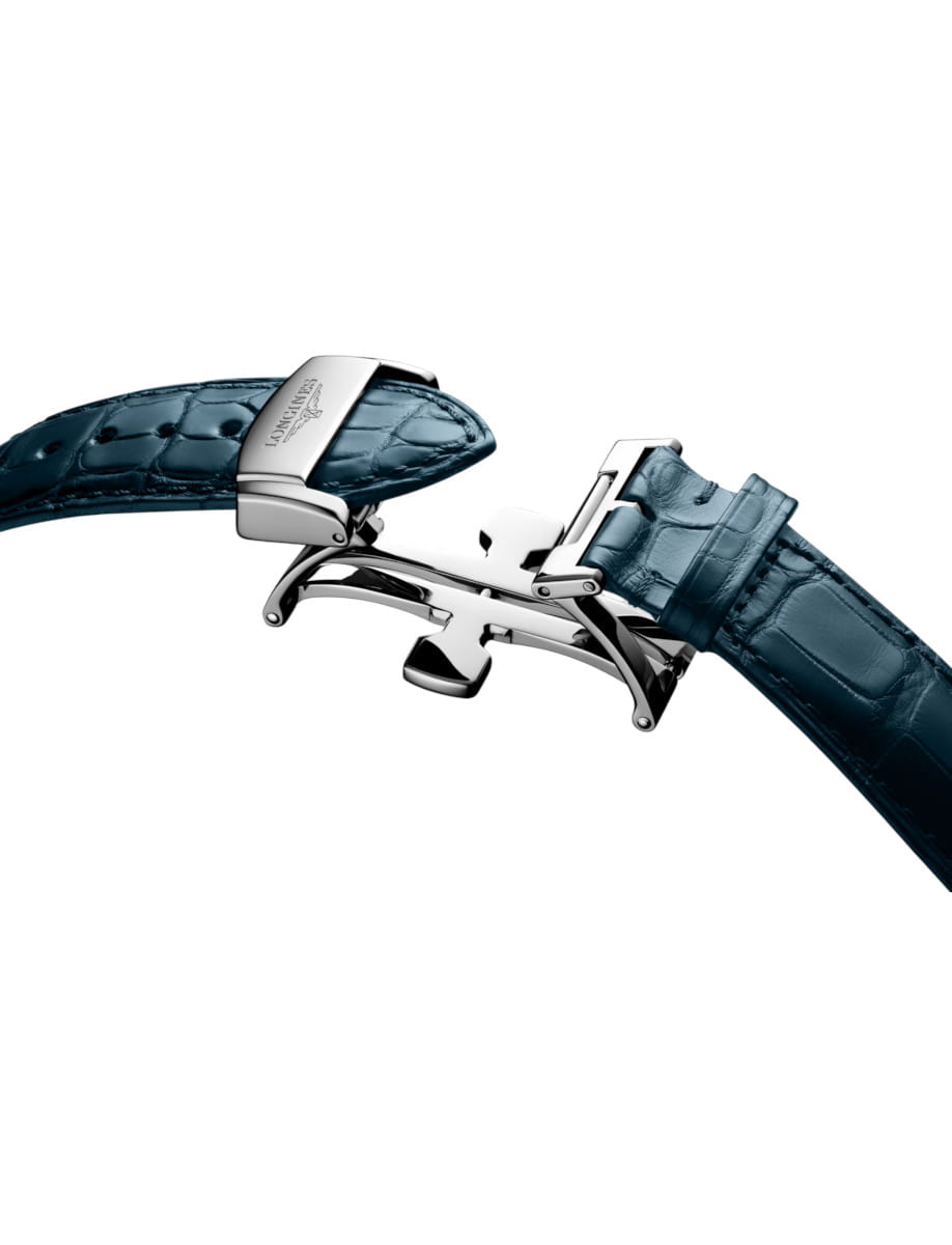 Close-up of a blue leather watch strap with a steel deployment clasp in the open position, highlighting the premium hardware