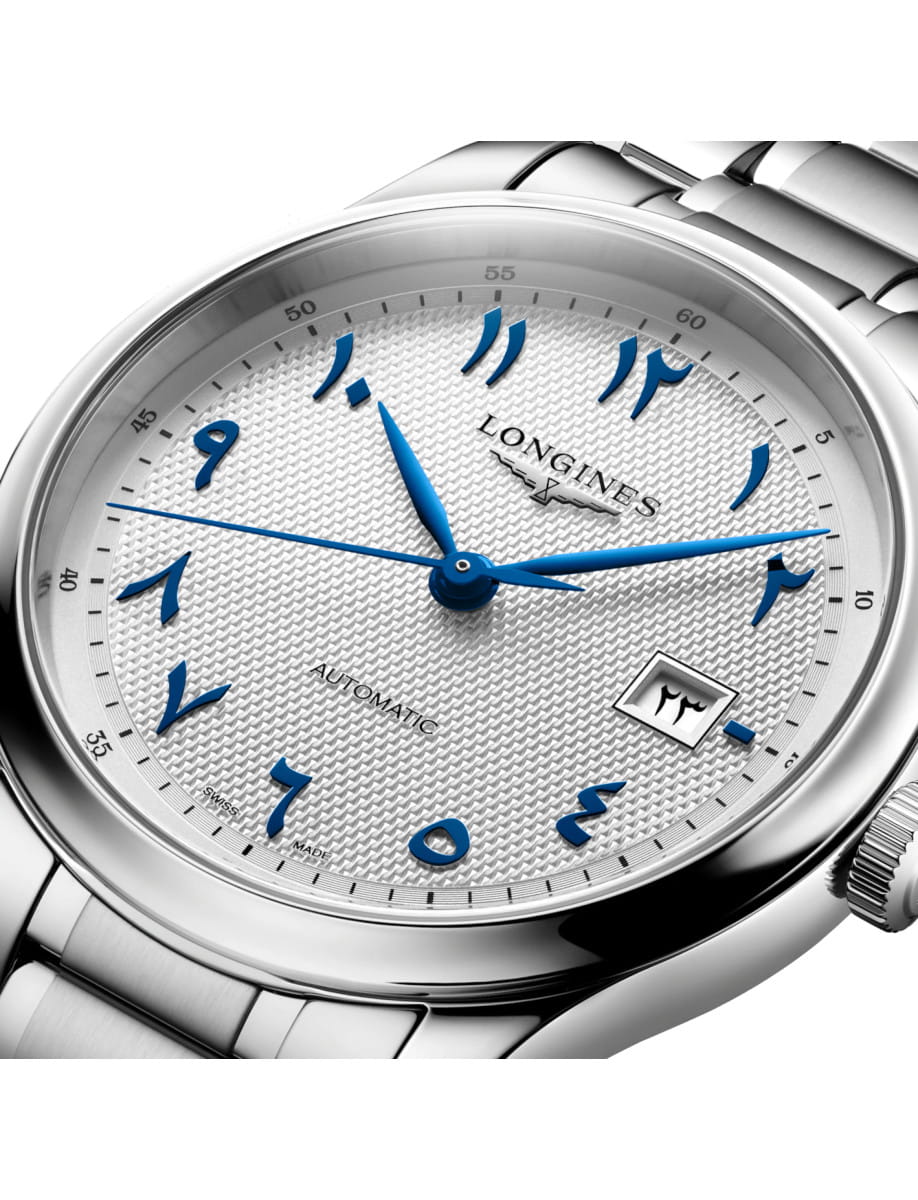 Longines automatic wristwatch with blue Arabic numerals, silver textured dial, blue hands, and a stainless steel bracelet.