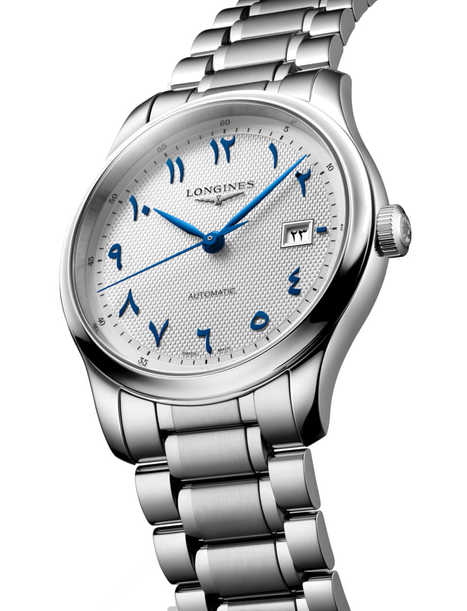 Side view of Longines stainless steel wristwatch with blue Arabic numerals and a textured white dial, Longines branding, and a date window at 3 o'clock.