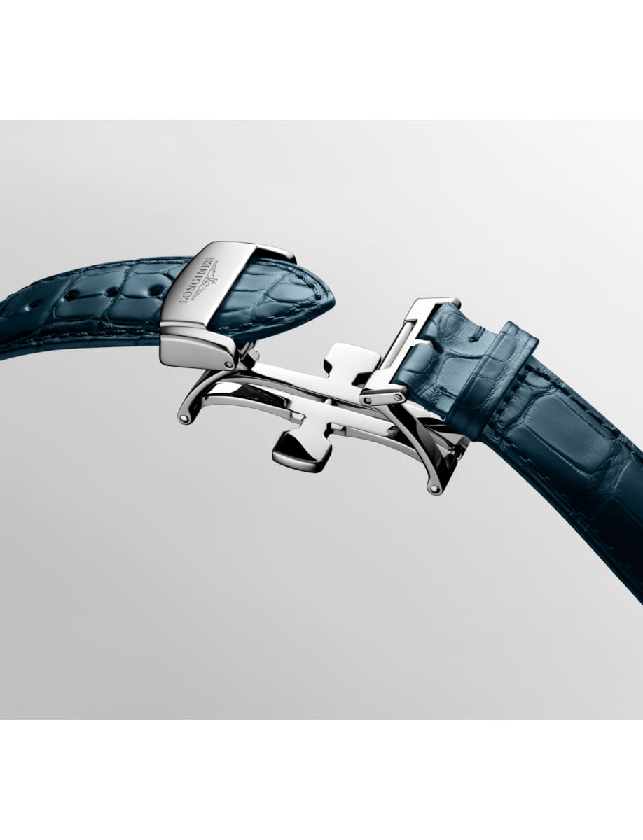Close-up of a blue leather watch strap with a silver deployment clasp in the open position, highlighting the premium hardware