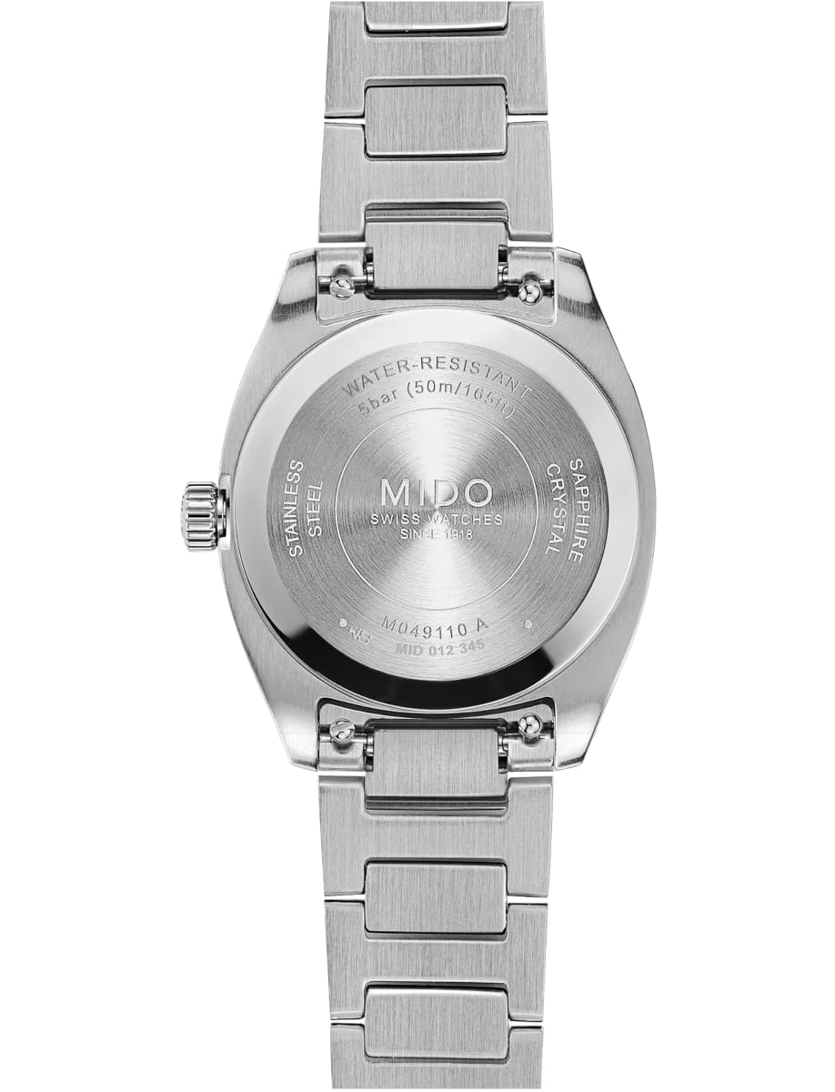 Back of a stainless steel wristwatch with engraved brand name MIDO and water-resistance markings visible on the caseback, metal bracelet extending above and below the case.