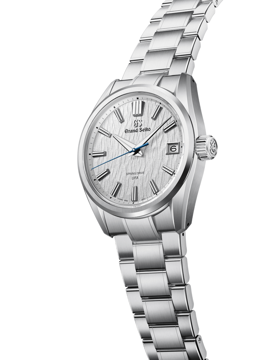 Side view of Grand Seiko wristwatch with Ever brilliant steel case and bracelet, and white dial.