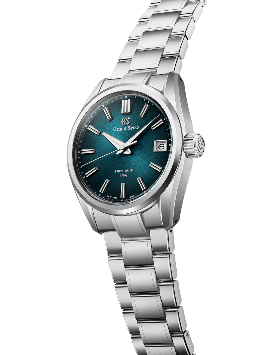 Side view of Grand Seiko wristwatch with Ever brilliant steel case and bracelet, and blue-green dial.