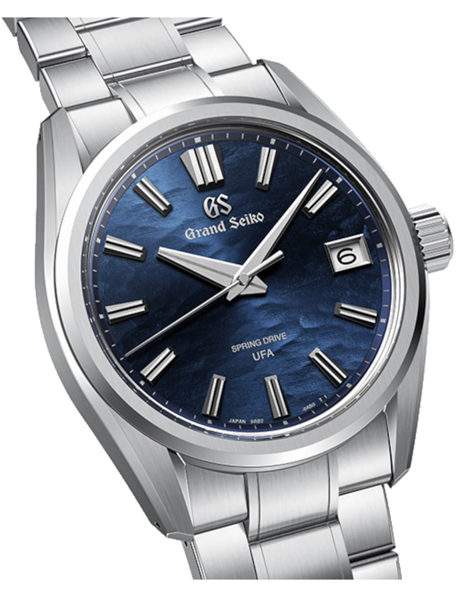 Front side view of Grand Seiko wristwatch with stainless steel case and bracelet, and blue dial.
