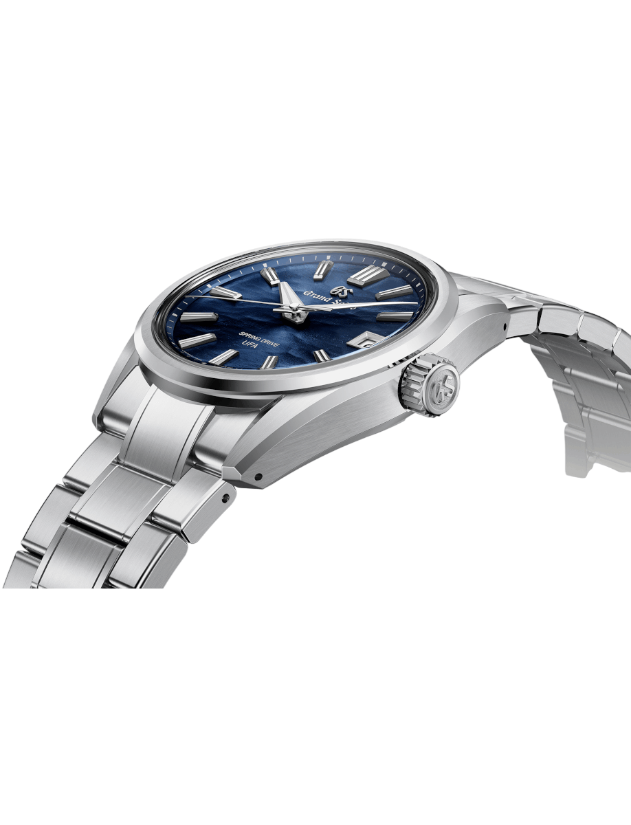 Side view of Grand Seiko wristwatch with Ever brilliant steel case and bracelet, and blue dial.
