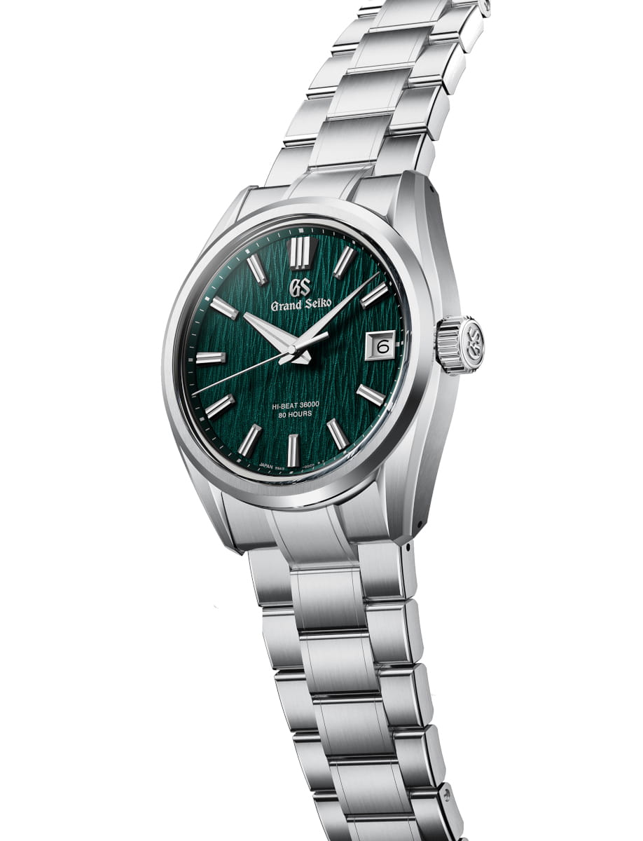 Side view of Grand Seiko wristwatch with Ever brilliant steel case and bracelet, and green dial.