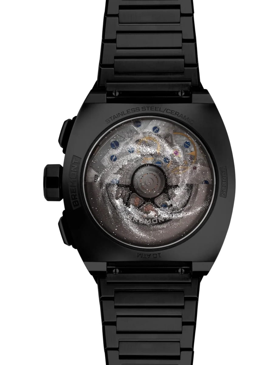Black wristwatch with a transparent case back showing the internal mechanical movement.