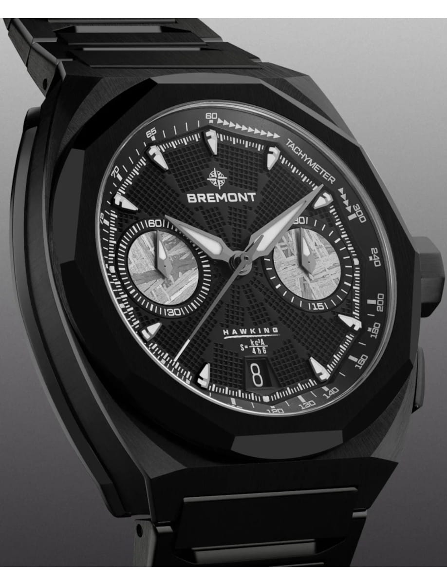 Close-up of a black Bremont Hawking chronograph watch with tachymeter bezel and two silver subdials on a textured dial, date window at 6 o'clock