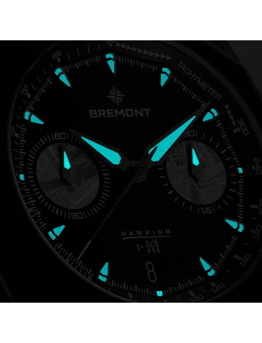 Close-up of a Bremont Hawking chronograph dial with turquoise luminescent hands and markers