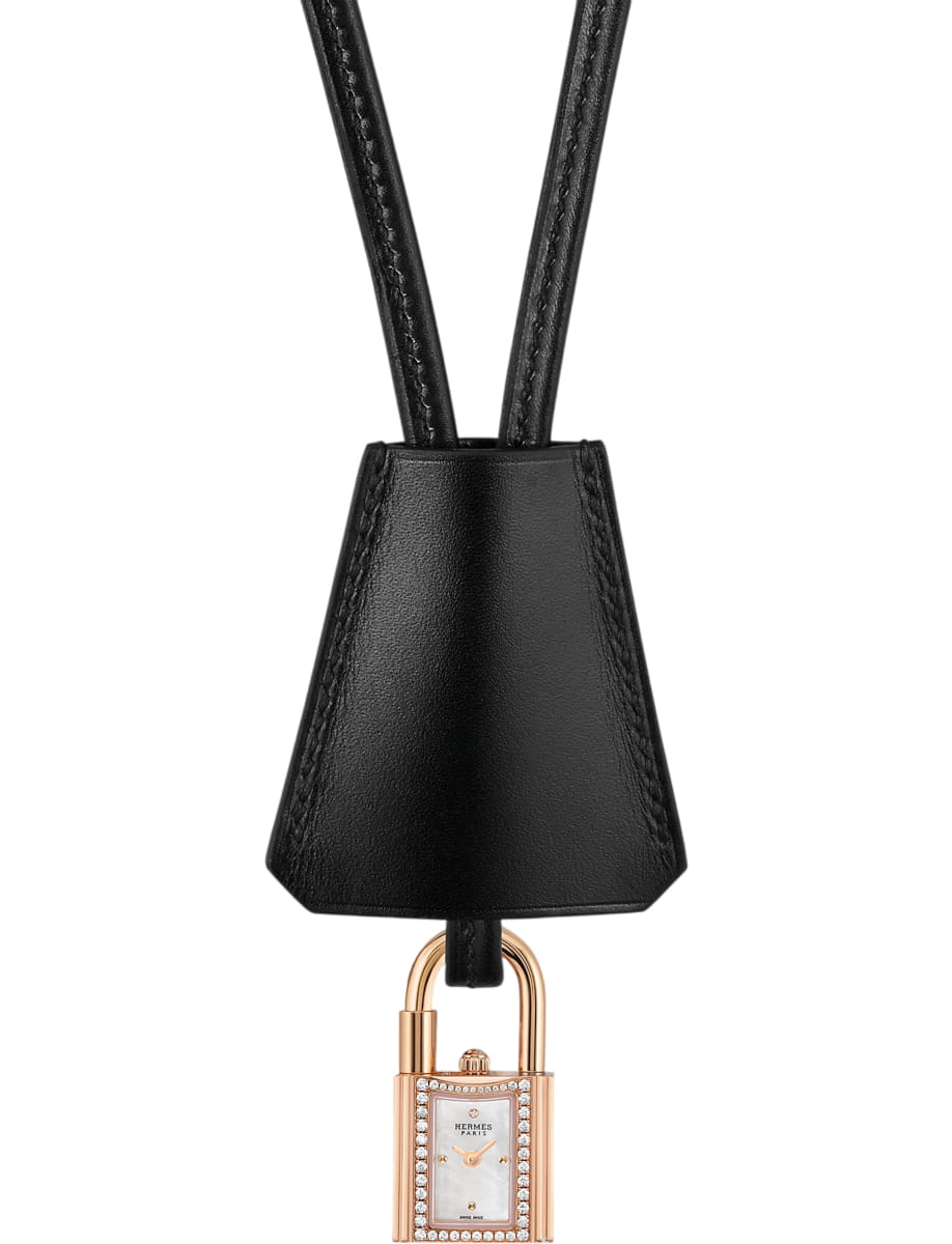 Black leather strap with a small rose-gold padlock watch charm hanging at the bottom.