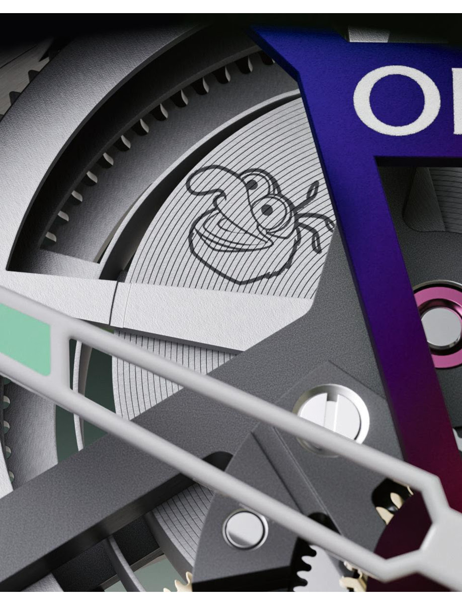 Close-up of industrial gears and metal components with a crab illustration on a circular disc, part of a blue-framed machine.