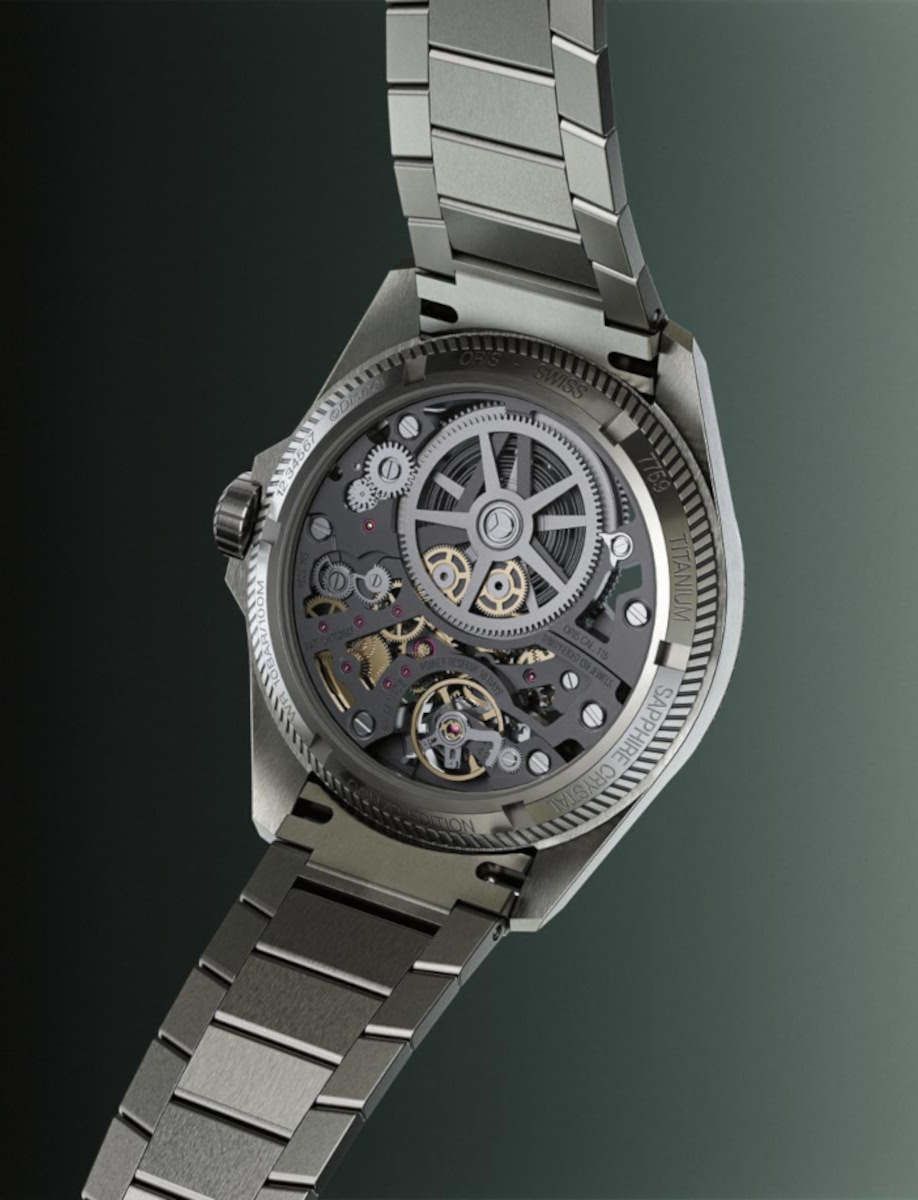 Back view of a skeleton mechanical watch showing visible gears, rotor, and stainless steel bracelet