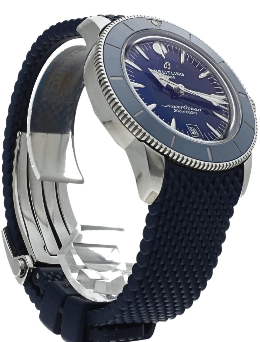 Pre-owned Breitling Super Ocean watch with blue dial and blue textured strap, close-up.