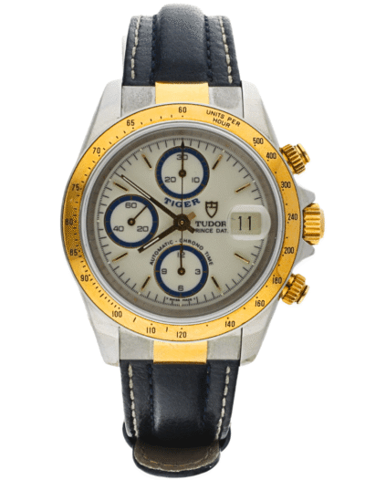 Tudor Prince chronograph wristwatch with a gold bezel, white dial, blue subdials, and a blue leather strap; date display shows 11.