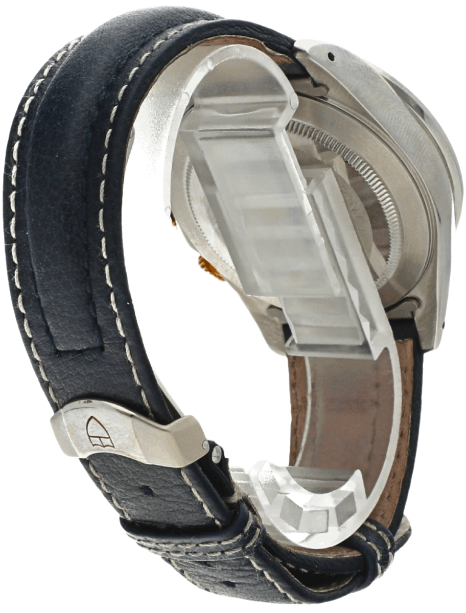 Close-up of a wristwatch with a blue leather strap, white stitching, and a metal deployment clasp viewed from the side.