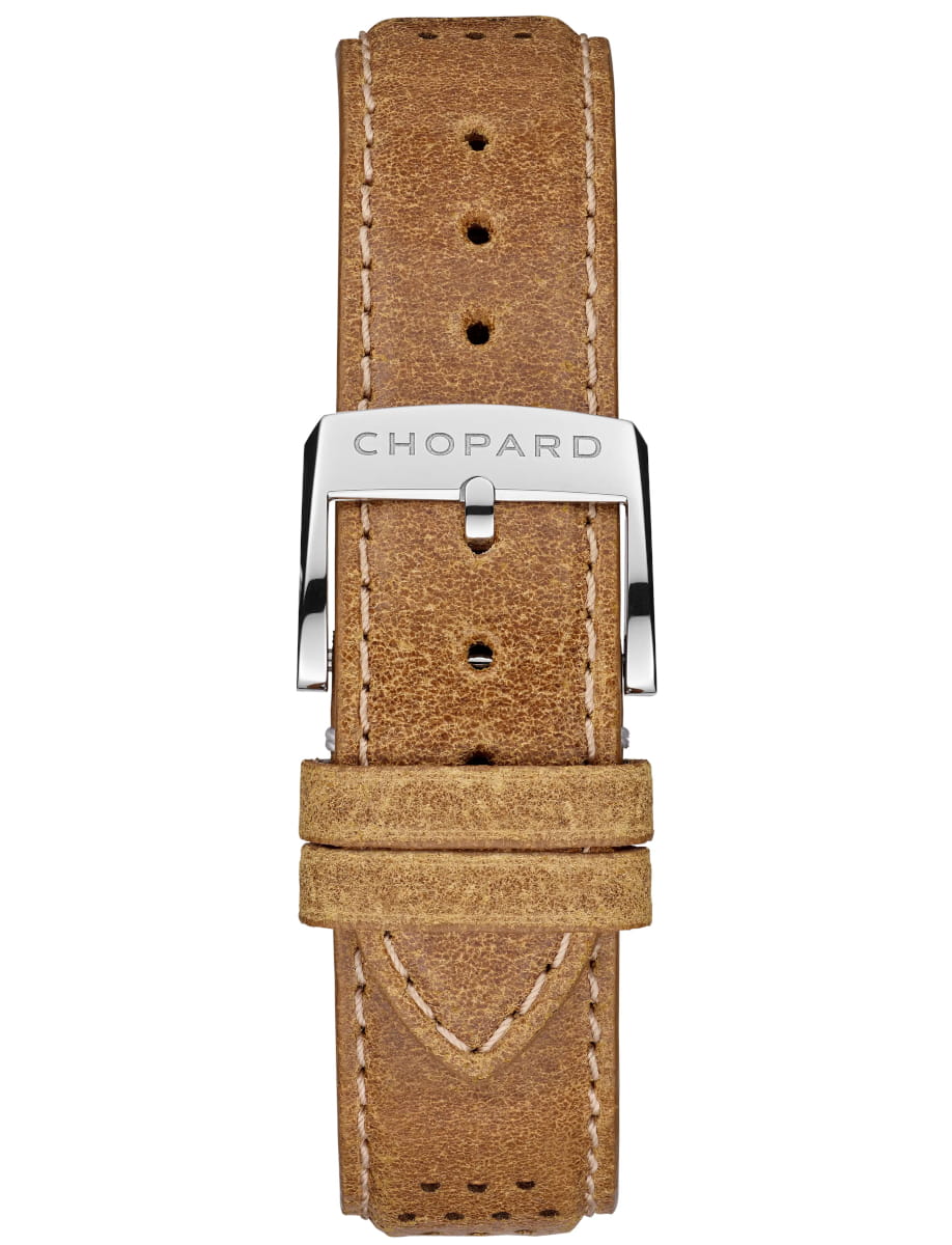 Brown distressed leather watch strap with white stitching and a polished silver buckle engraved 'CHOPARD'.