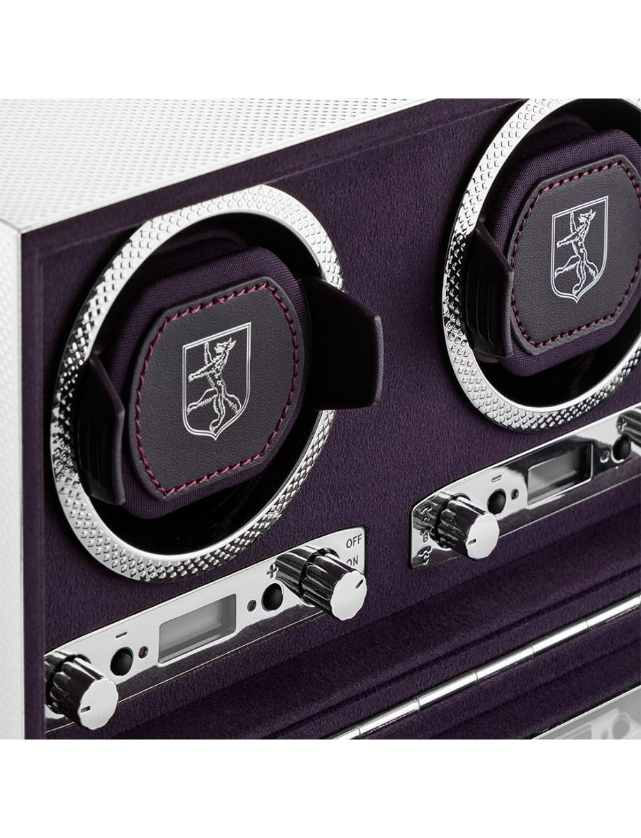 Close-up of a purple guitar amplifier front panel with two large chrome-ringed knobs and cushioned logo pads.