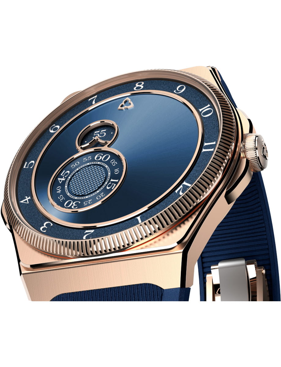 Close-up of a gold wristwatch with a blue dial and layered circular rings for a luxurious look.