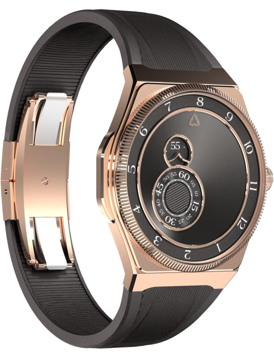Rose gold wristwatch with a black dial and textured bezel on a black rubber strap.