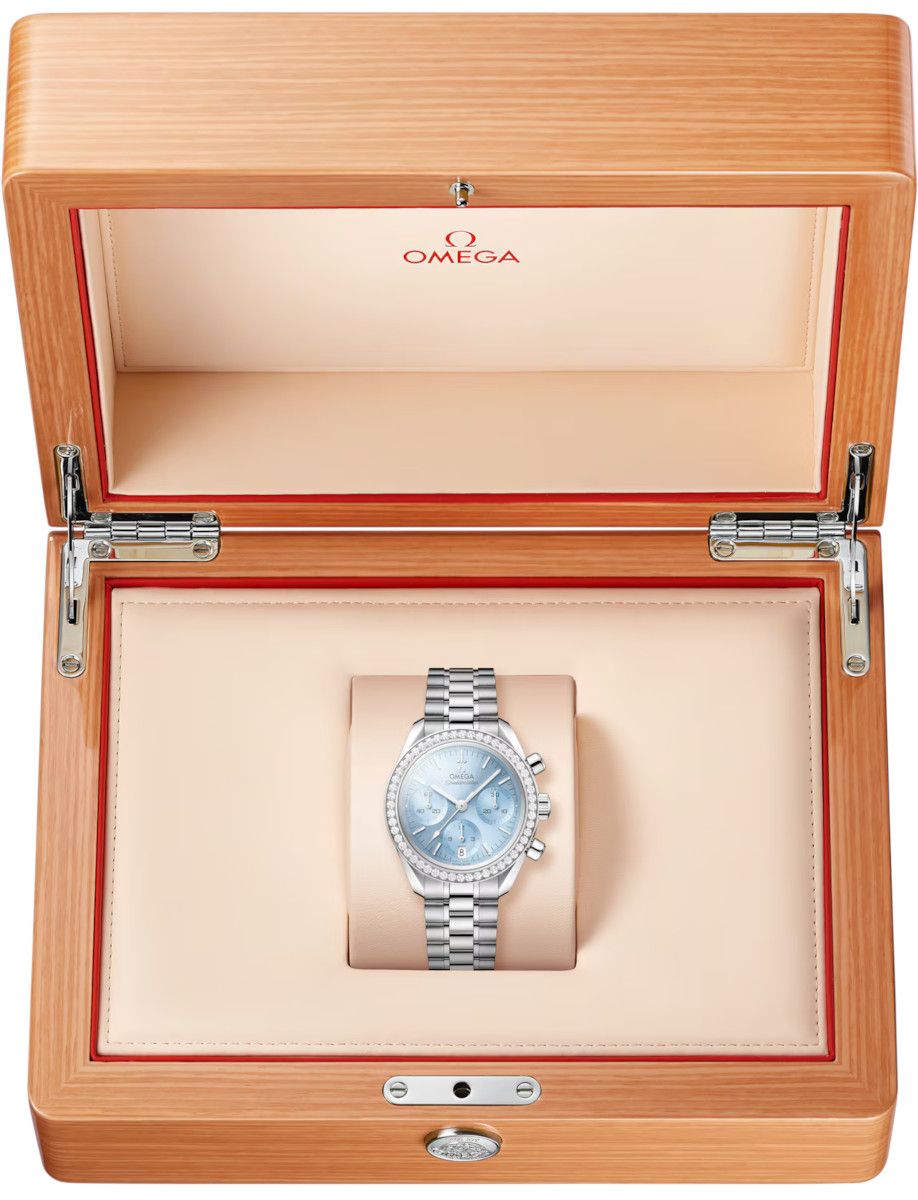 Omega wristwatch with blue dial and diamond bezel displayed in a wooden presentation box
