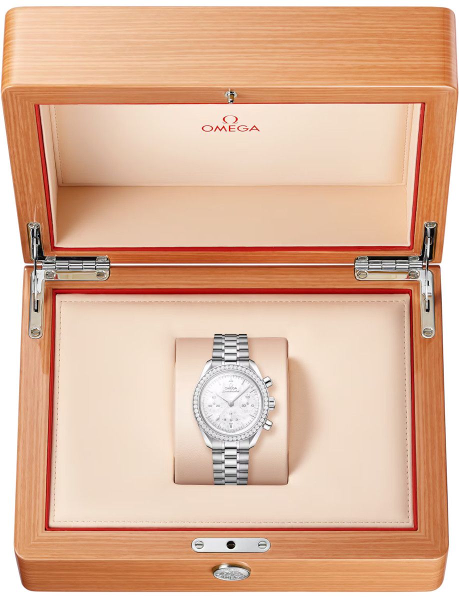 Omega wristwatch in a light beige padded display box with a polished silver bracelet and diamond-set bezel for presentation purposes.