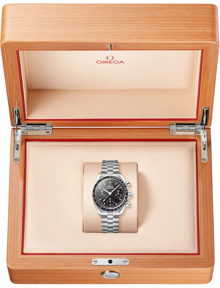 Omega stainless steel chronograph watch on a beige cushion inside an open wooden presentation box with red trim