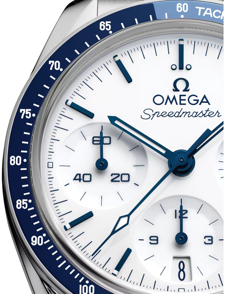 Close-up of an Omega Speedmaster chronograph dial with a blue tachymeter bezel and blue subdial hands.