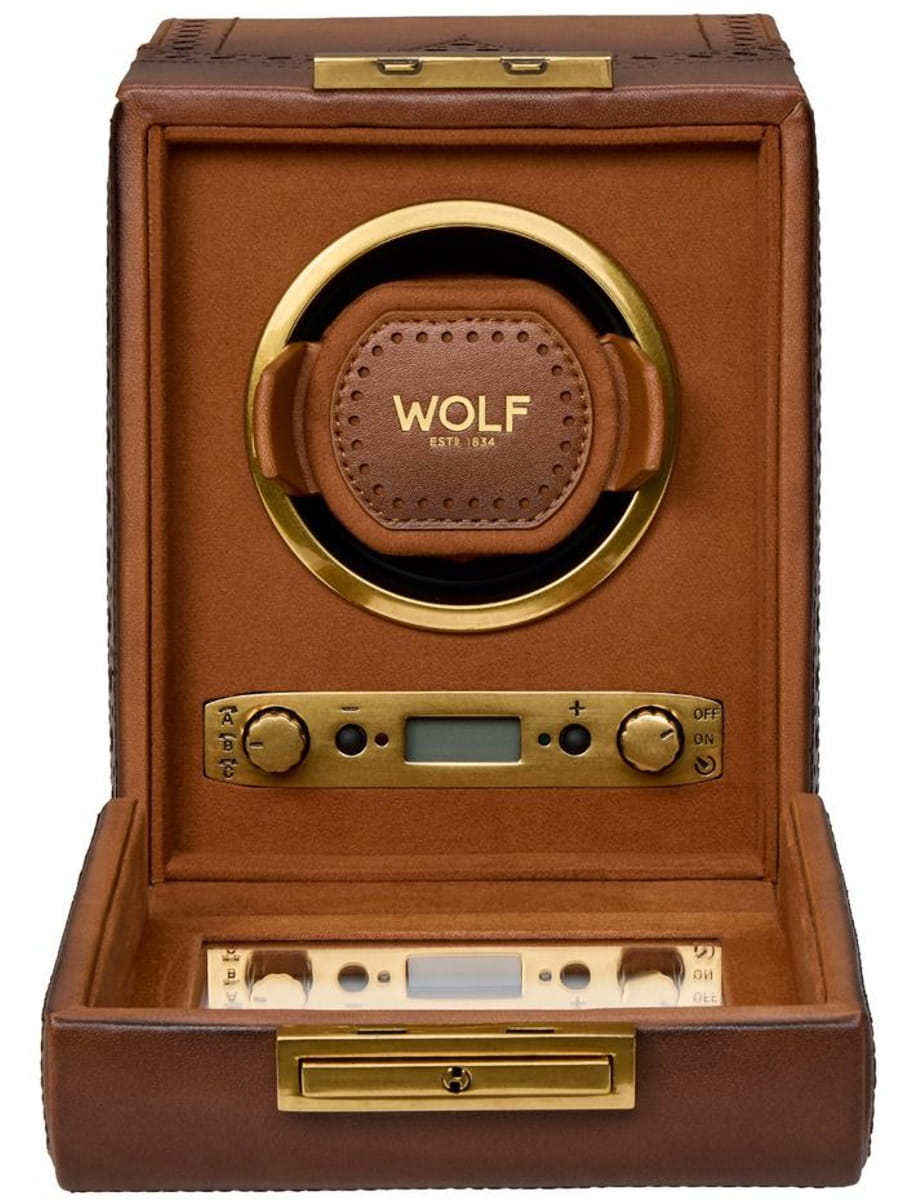 Brown leather-wrapped wooden Wolf humidor with a circular gold ring centerpiece and brass control panel at the front.