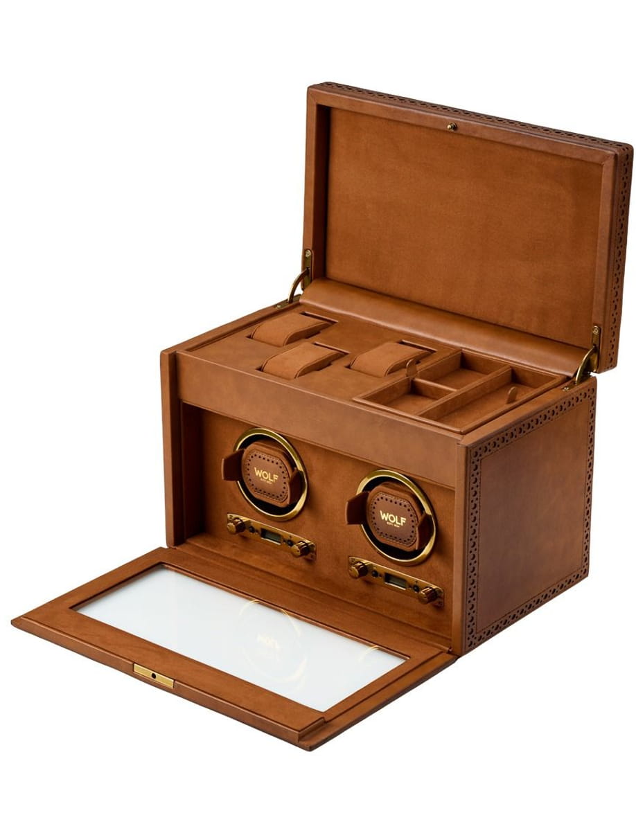 Brown leather watch winder box with two circular winders, lid open showing interior compartments and glass front panel
