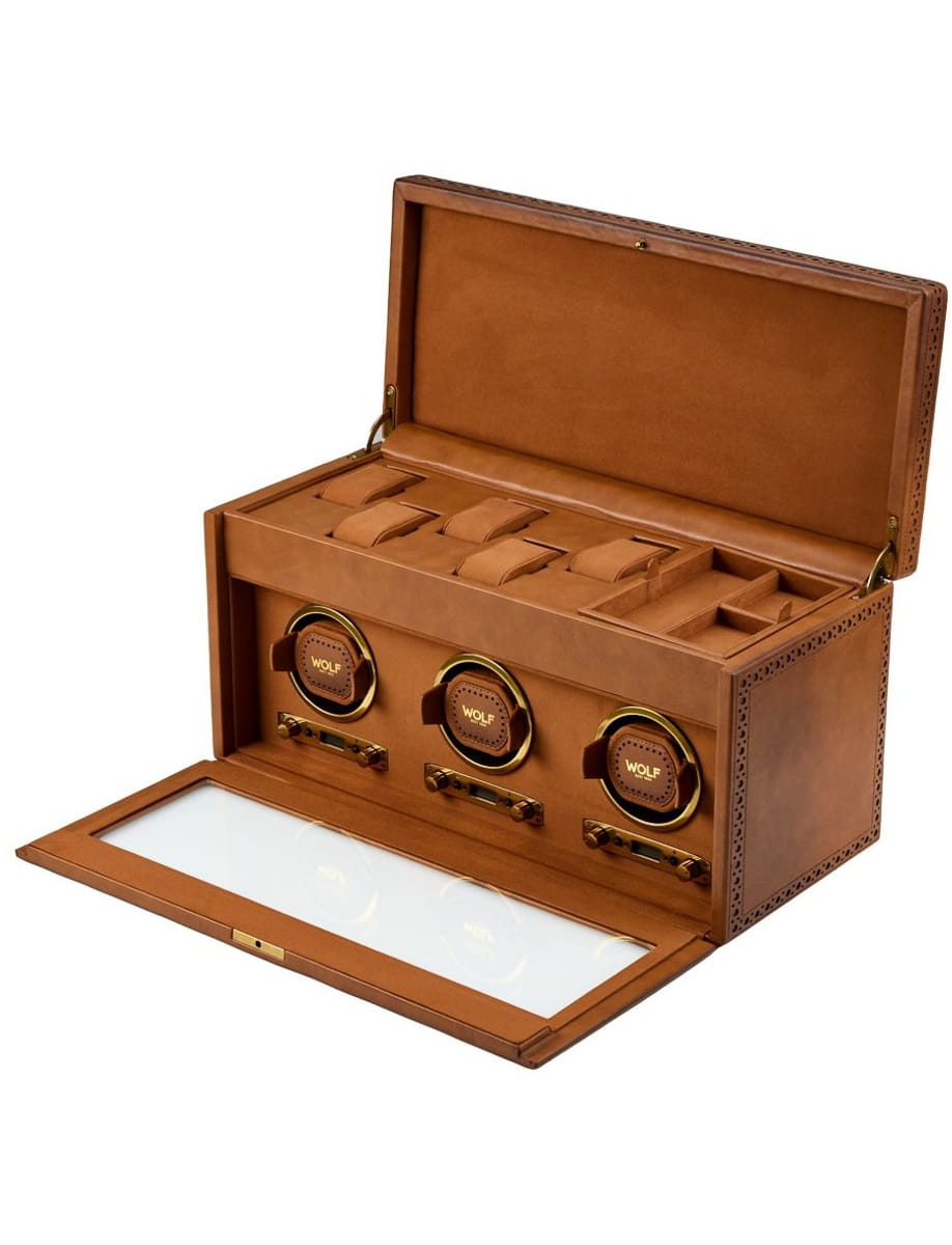 Brown leather watch storage box with three circular winders and a glass-topped lid, open to reveal compartments for more watches/Accessories.