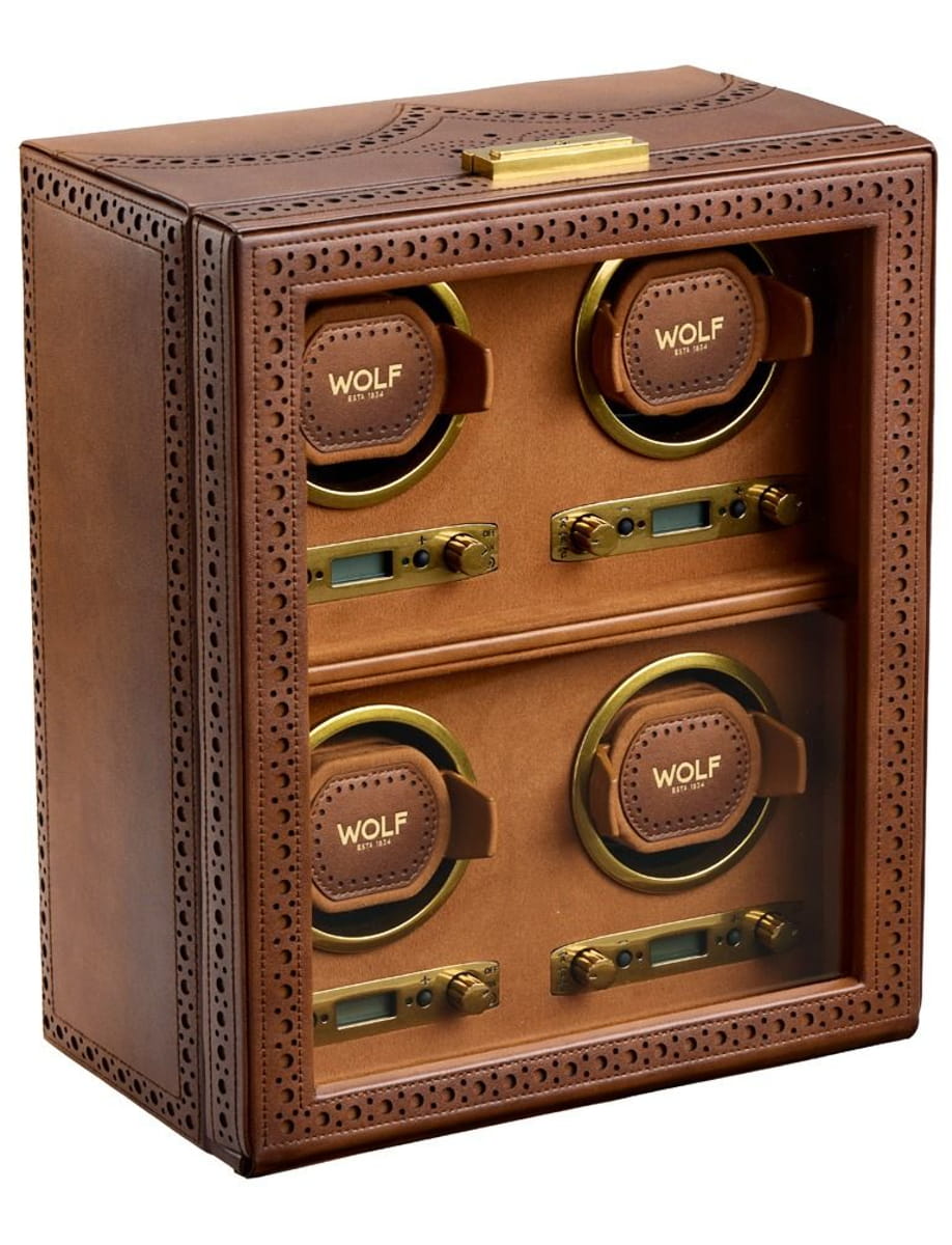 Brown leather Wolf watch winder box with four circular winders and brushed gold controls visible through a glass front.